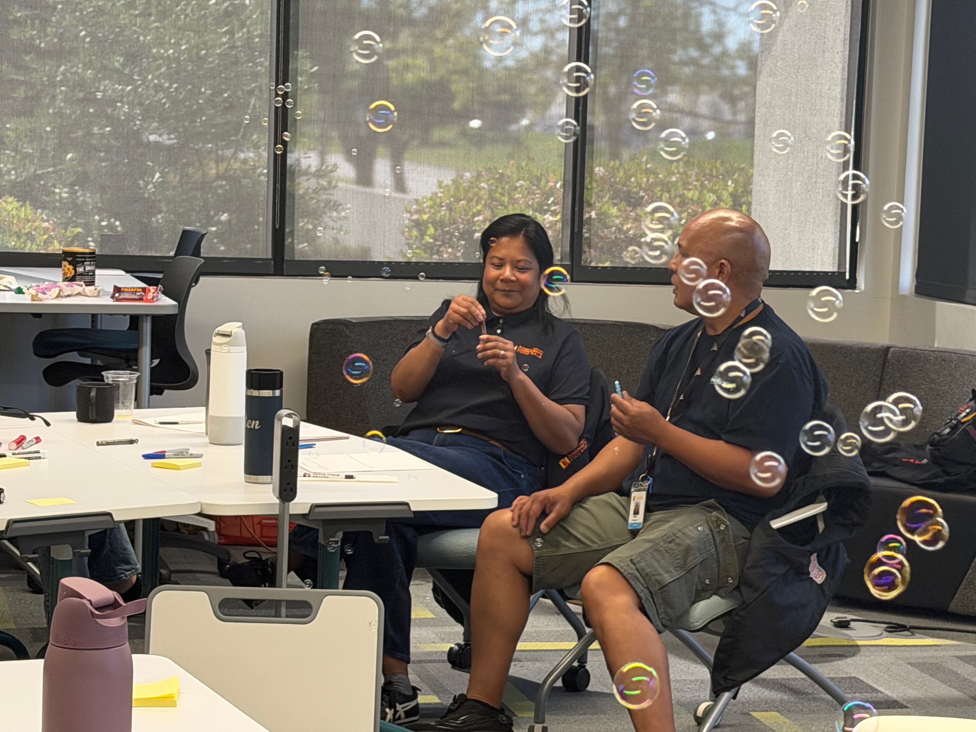 Alameda County Community Food Bank colleagues sharing a playful moment during the workshop