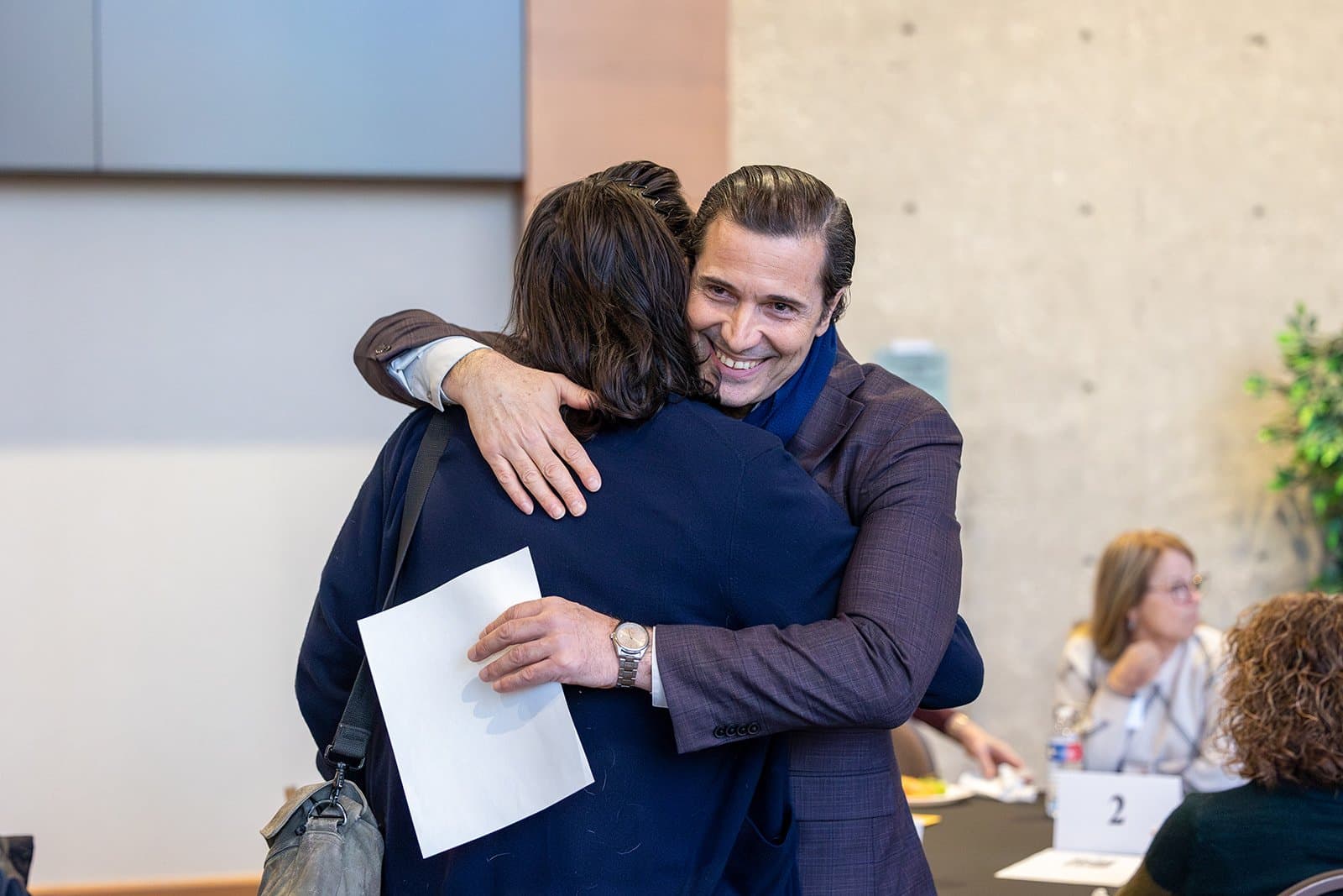 Two participants greeting one another at a Bringing Houston Together event