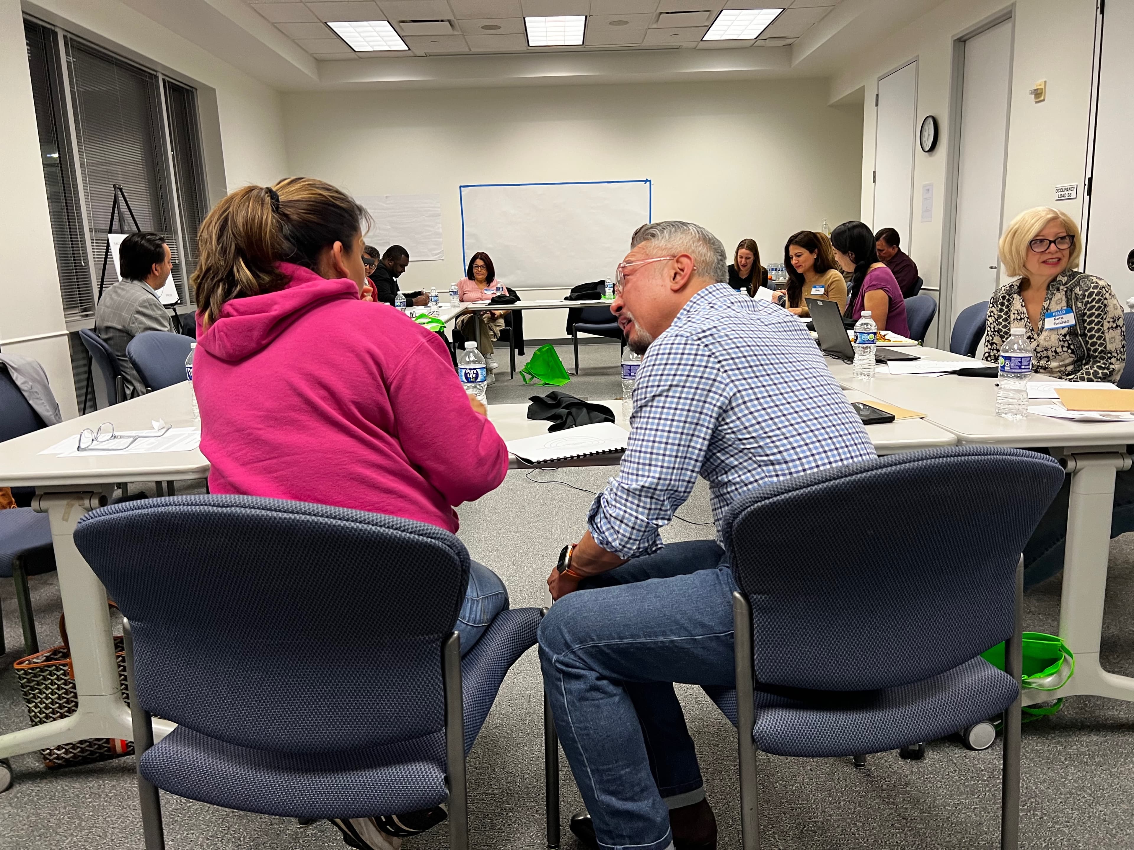 Dining with Purpose participants exchanging ideas around the table at Houston Food Bank