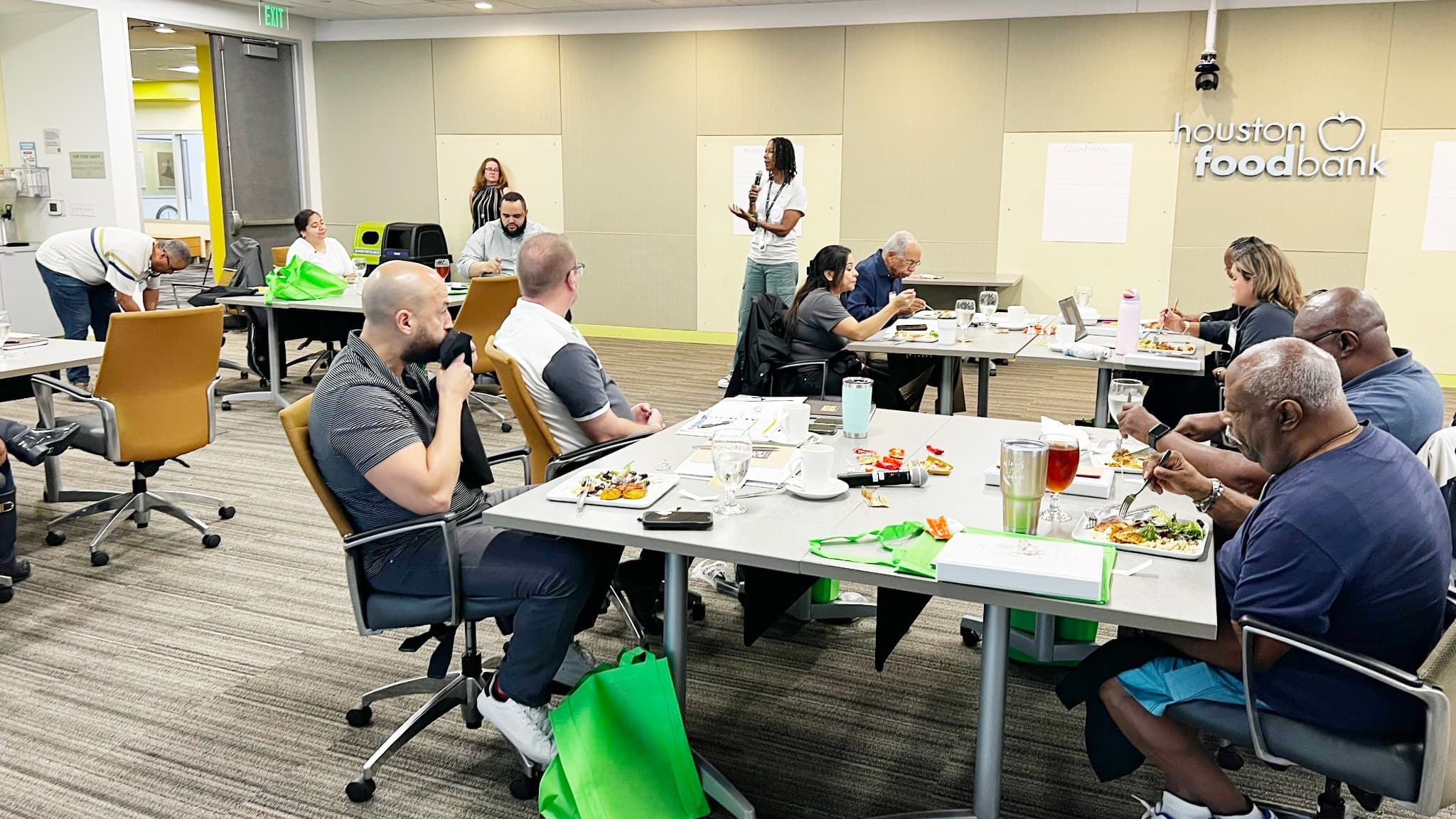 Dining with Purpose participants gathered around tables at the Houston Food Bank
