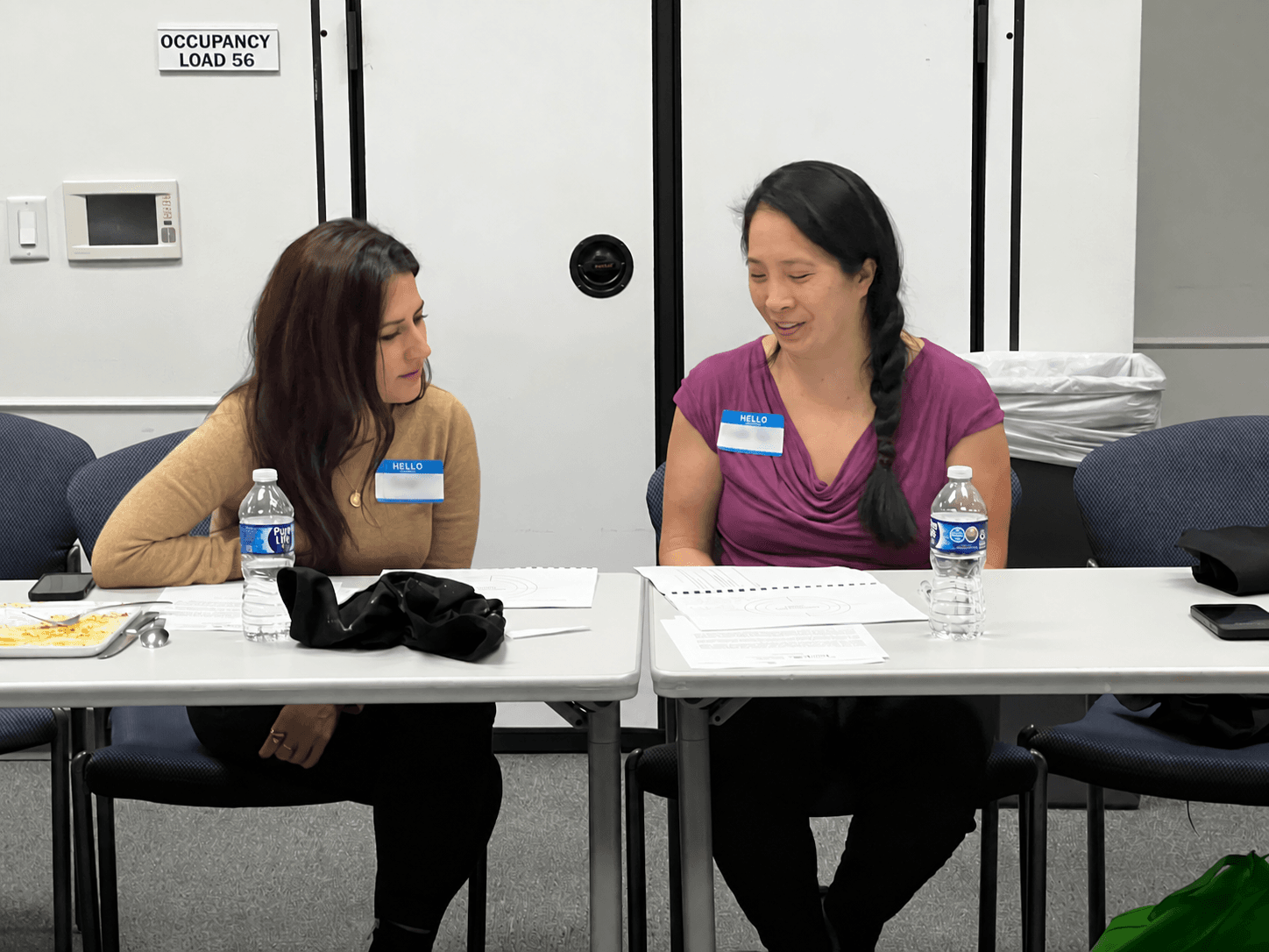 Two Dining with Purpose participants working through session materials together at Houston Food Bank.